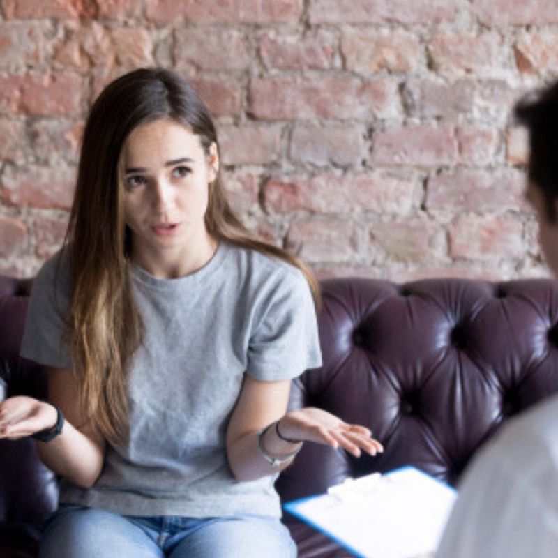 Young woman talking to counselor